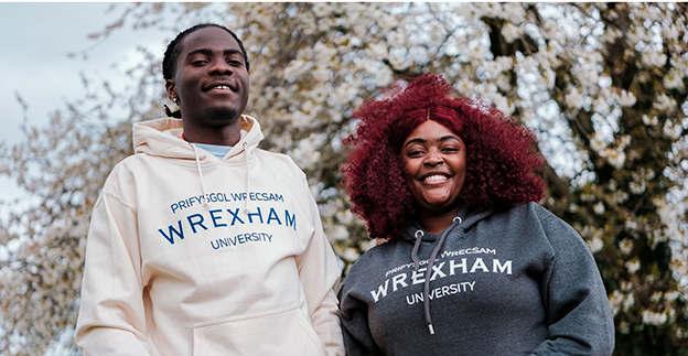 Two people standing and smiling