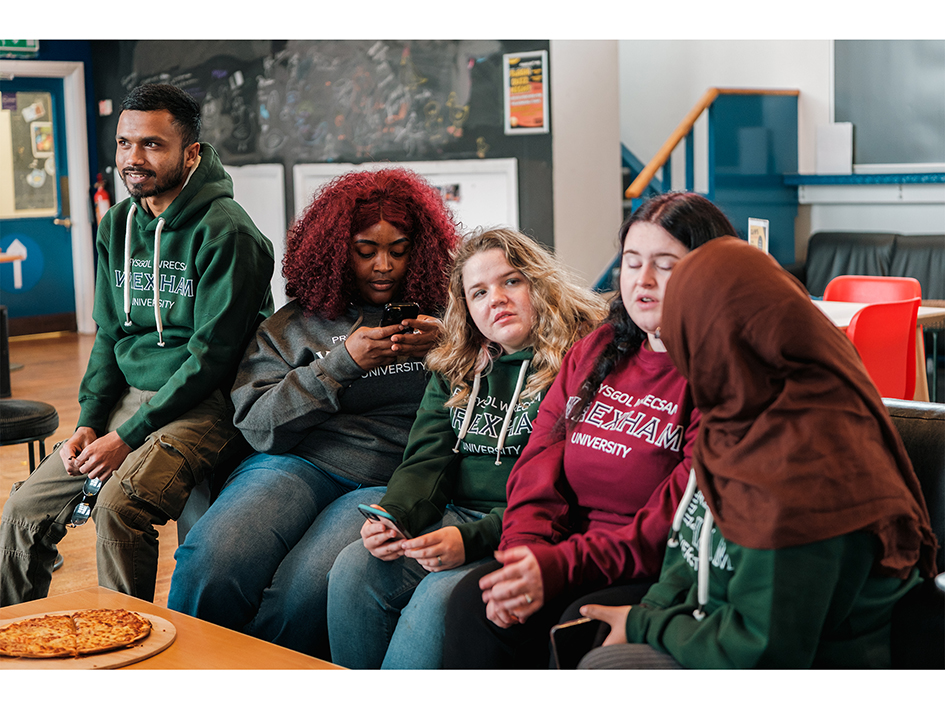 Students sitting on a sofa chatting