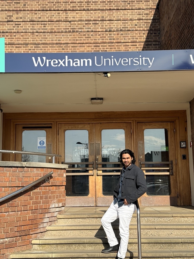A student standing outside university reception