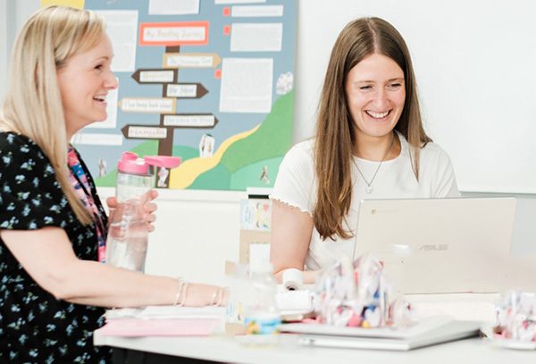 Two teachers at a table working