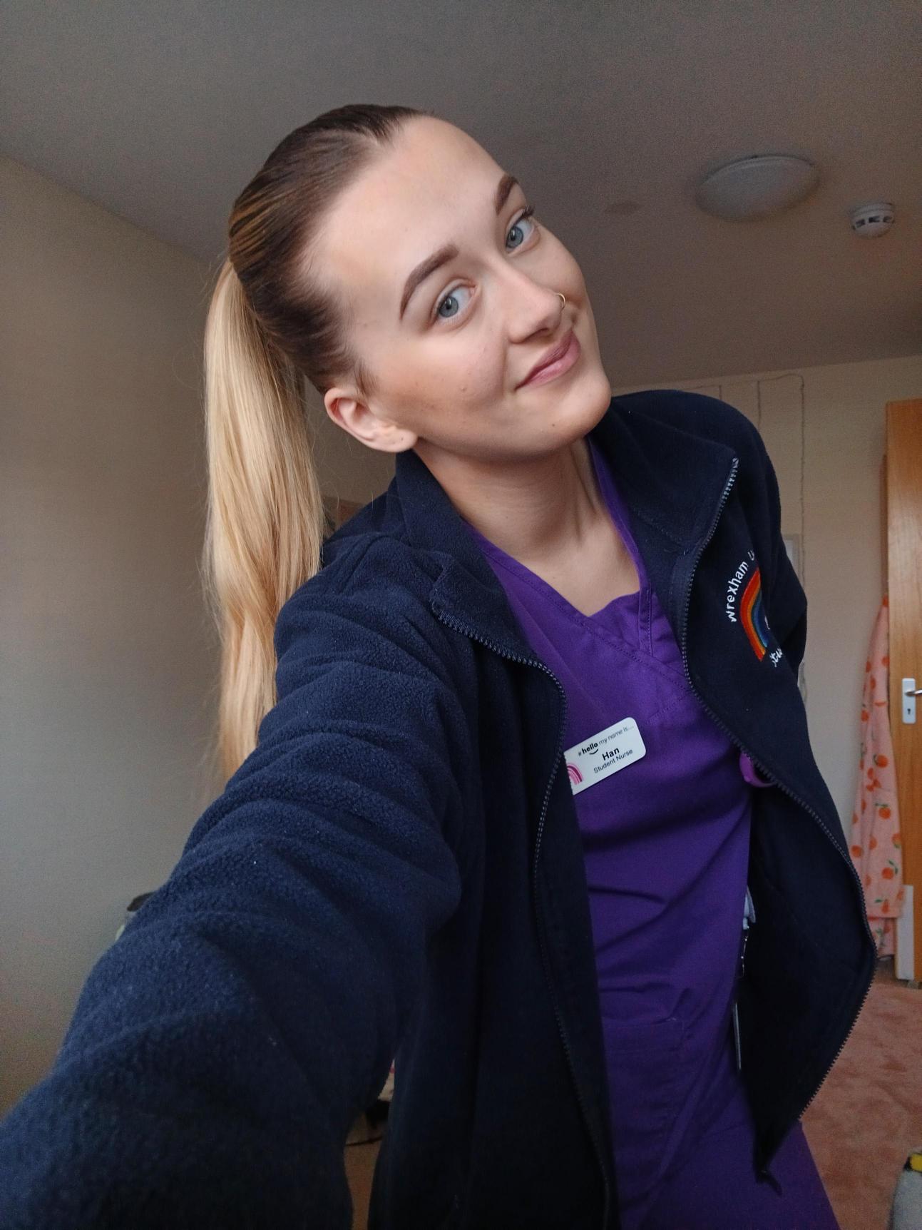 A student taking a selfie in their placement uniform