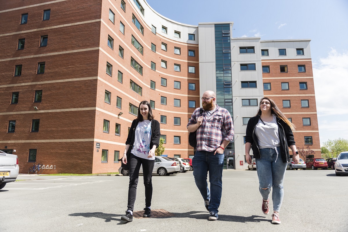 Students walking outside Wrexham Village accommodation