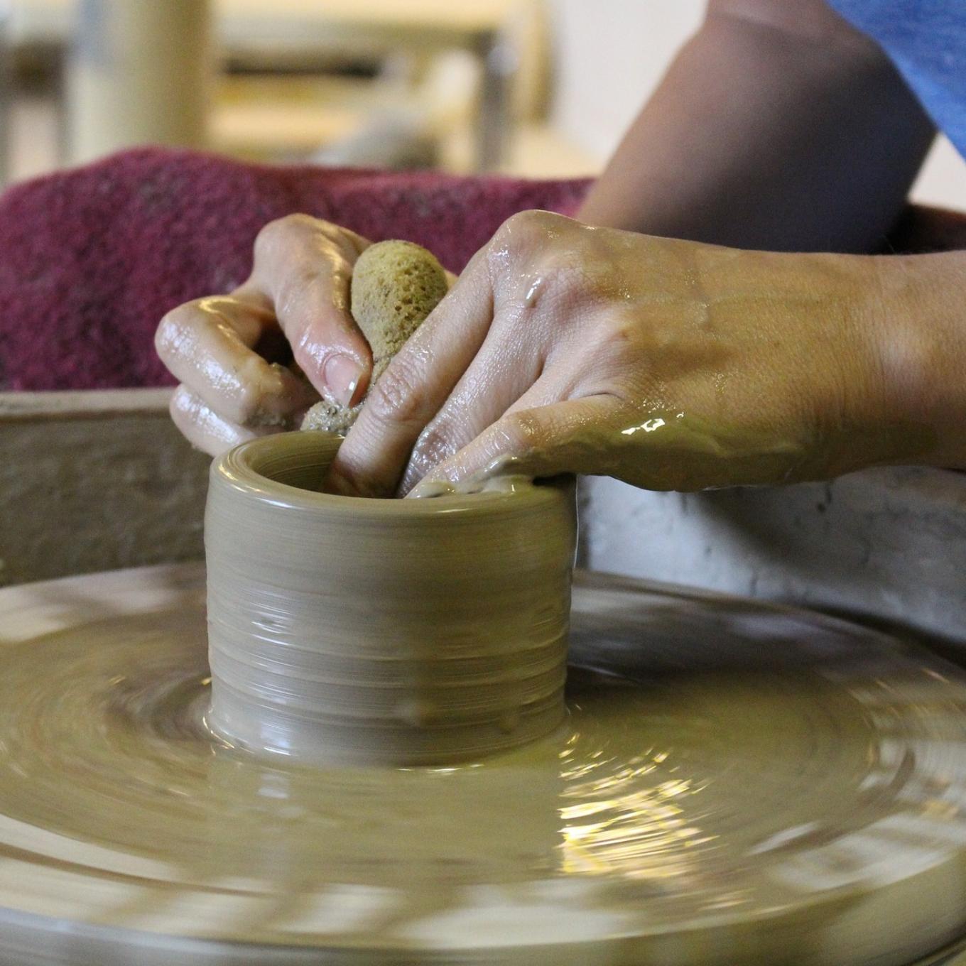 Close up of hands on a potters wheel