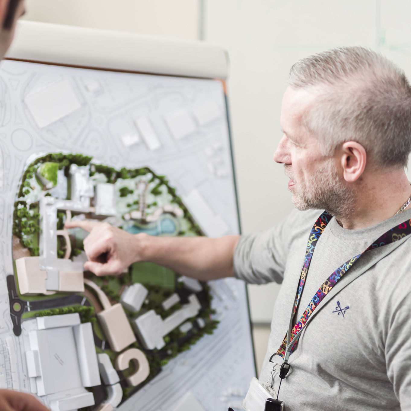 Lecturer Gareth Carr point out key features of a 3D building plan to a student