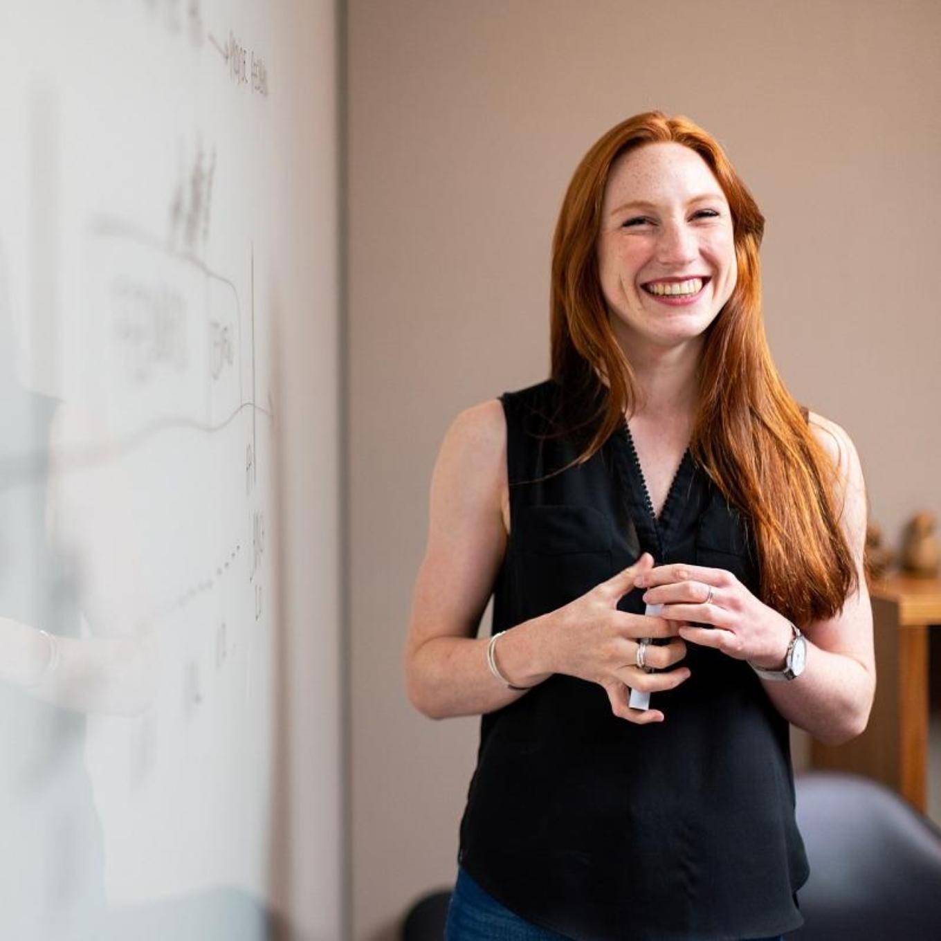 Woman standing in front of whiteboard