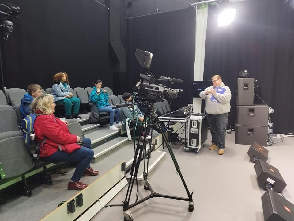 Kids in a tv studio with their parents