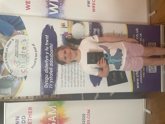 Child standing with Passport to Learning