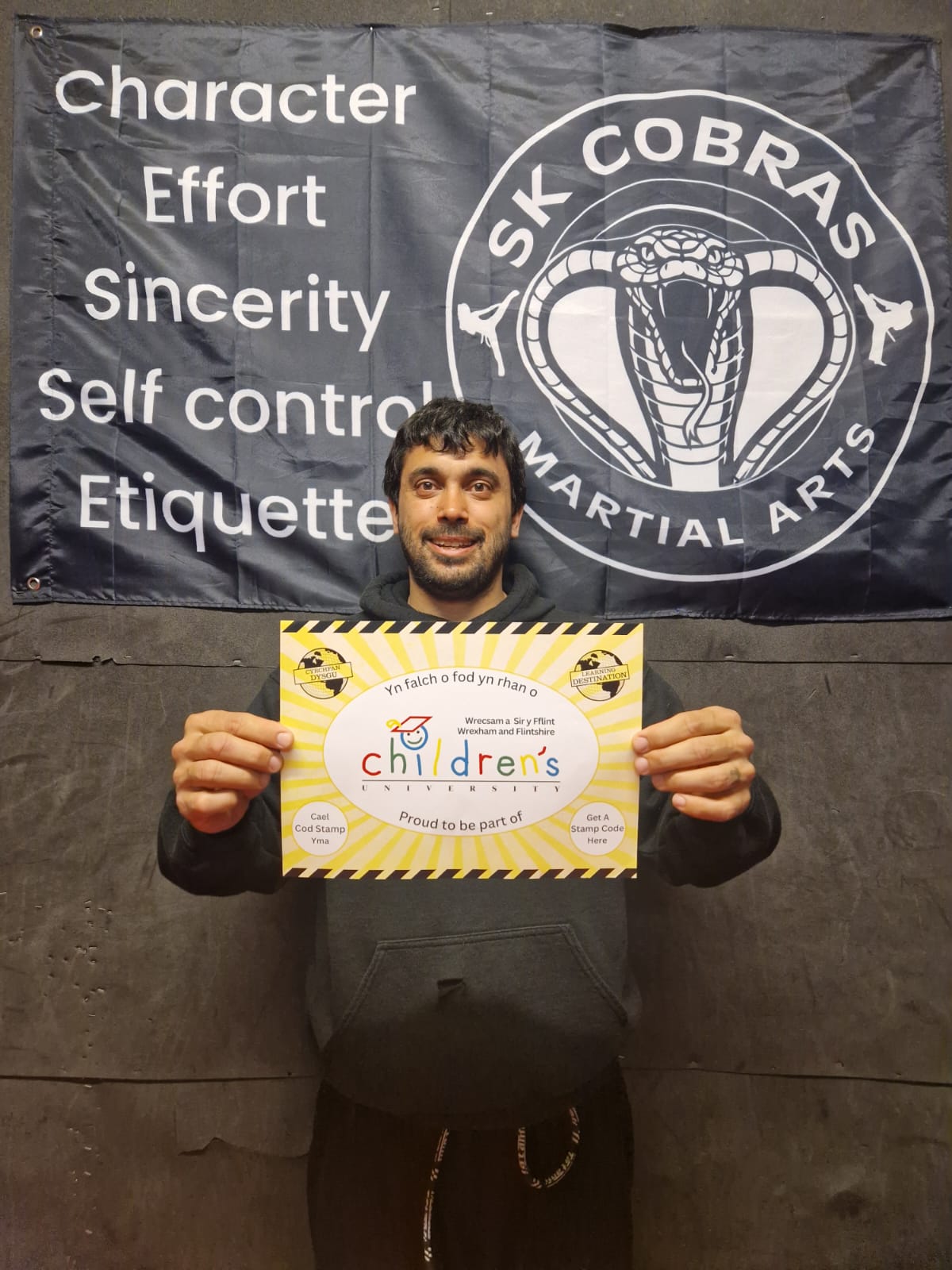 Man holding poster showing he's a learning destination for the childrens university