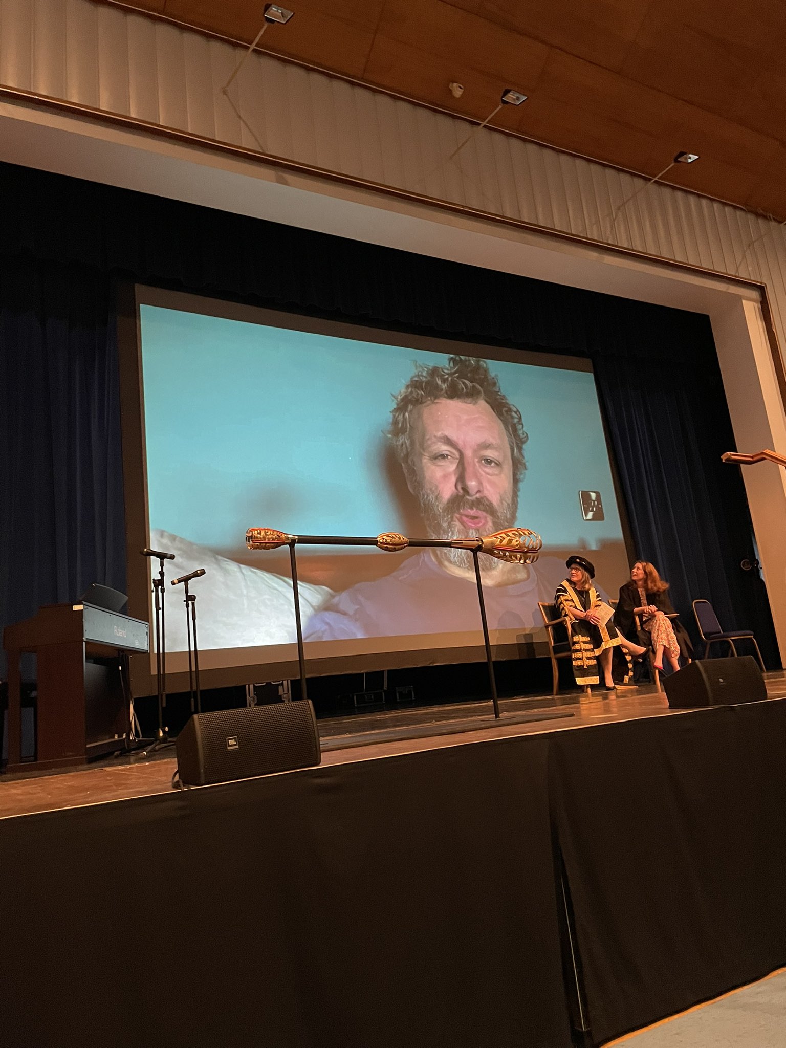 Michael Sheen on screen on stage at William Aston Hall