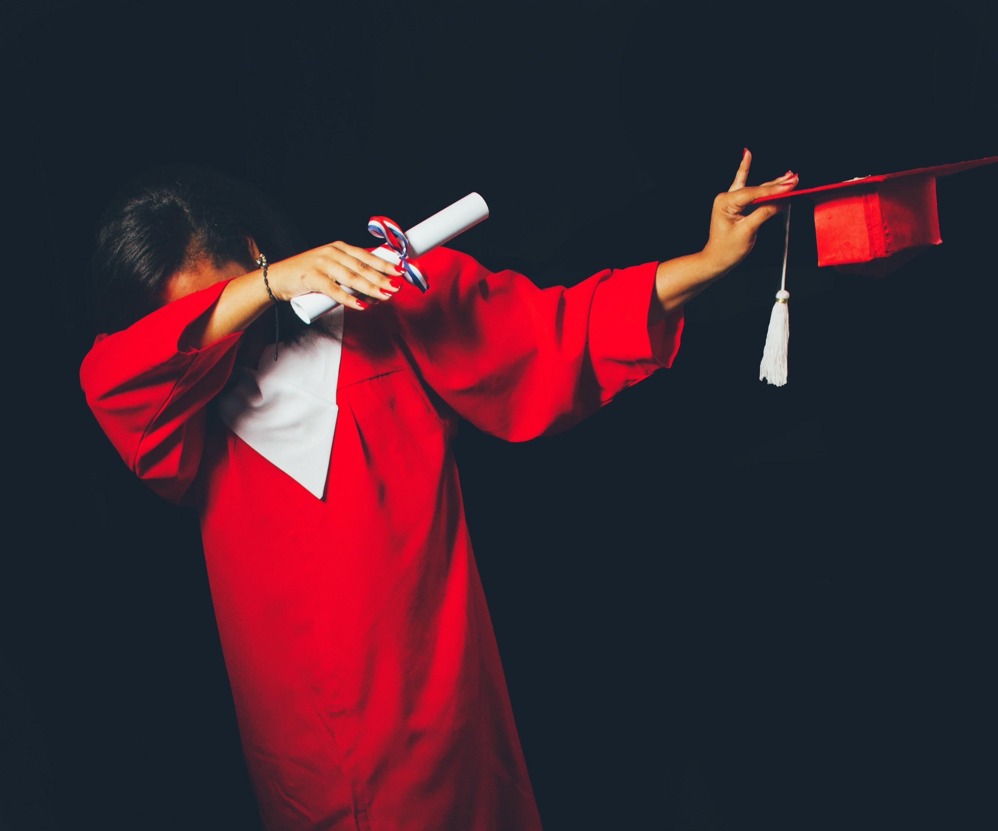 Kid dabbing in a graduation gown