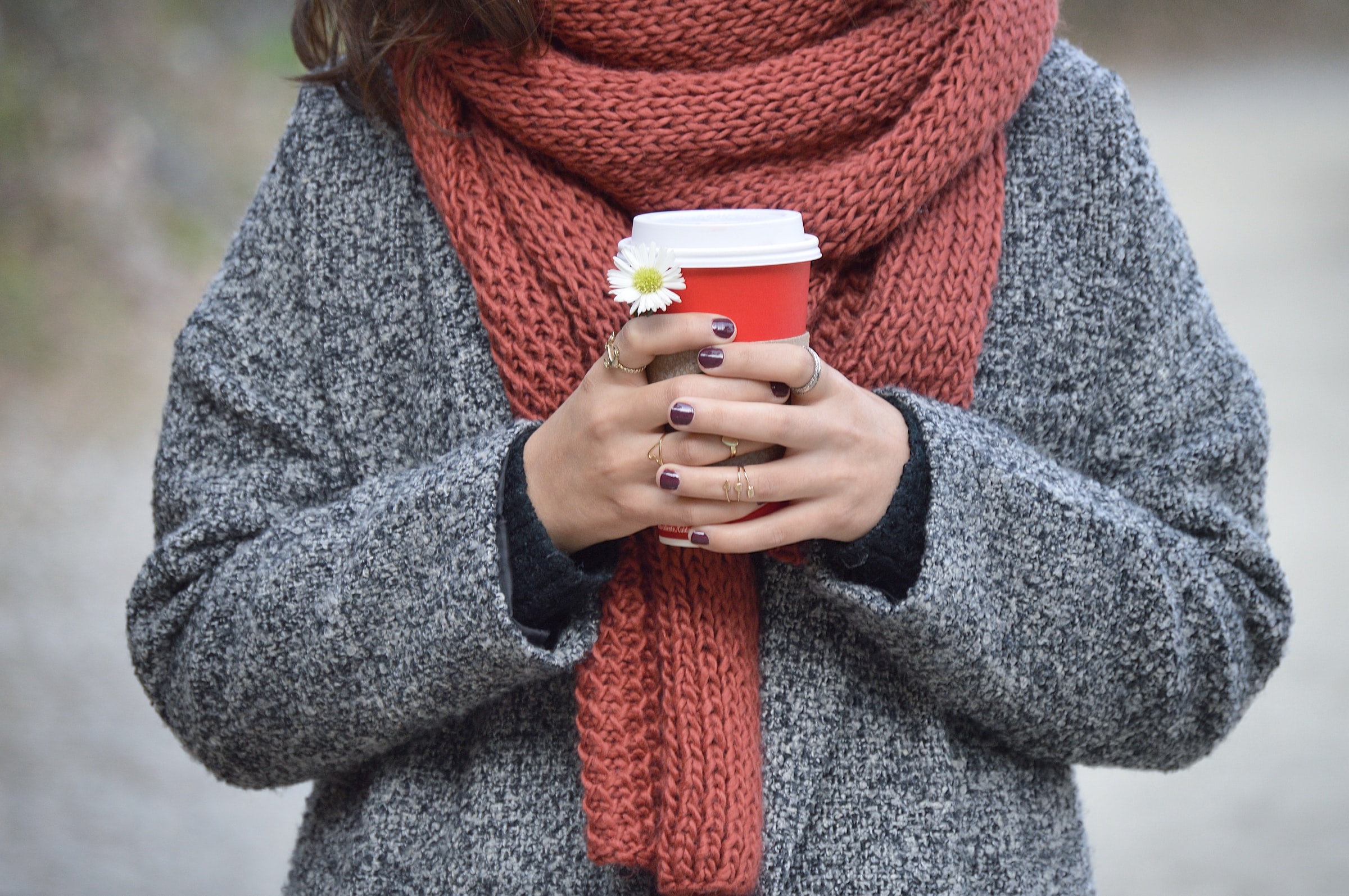 female holding hot drink