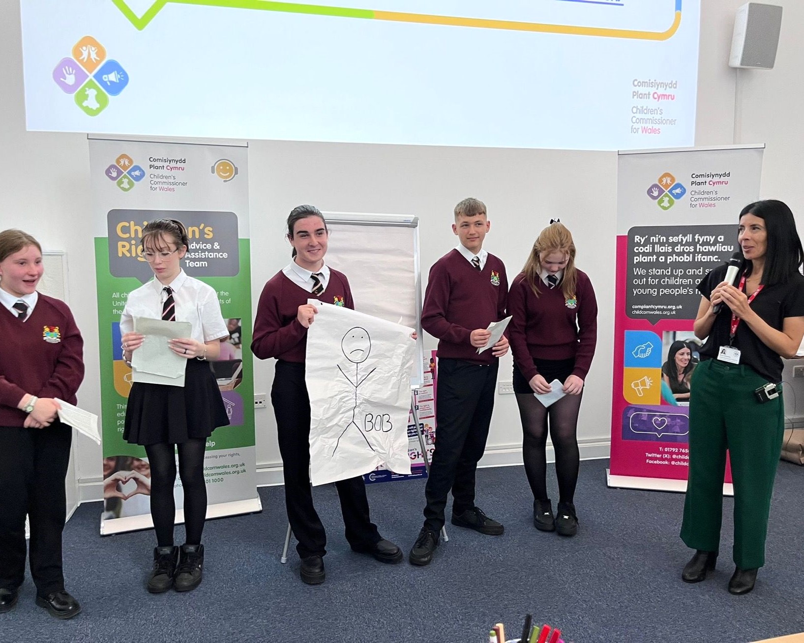 A group of students standing alongside the Children's Commissioner for Wales, Rocio Cifuentes.