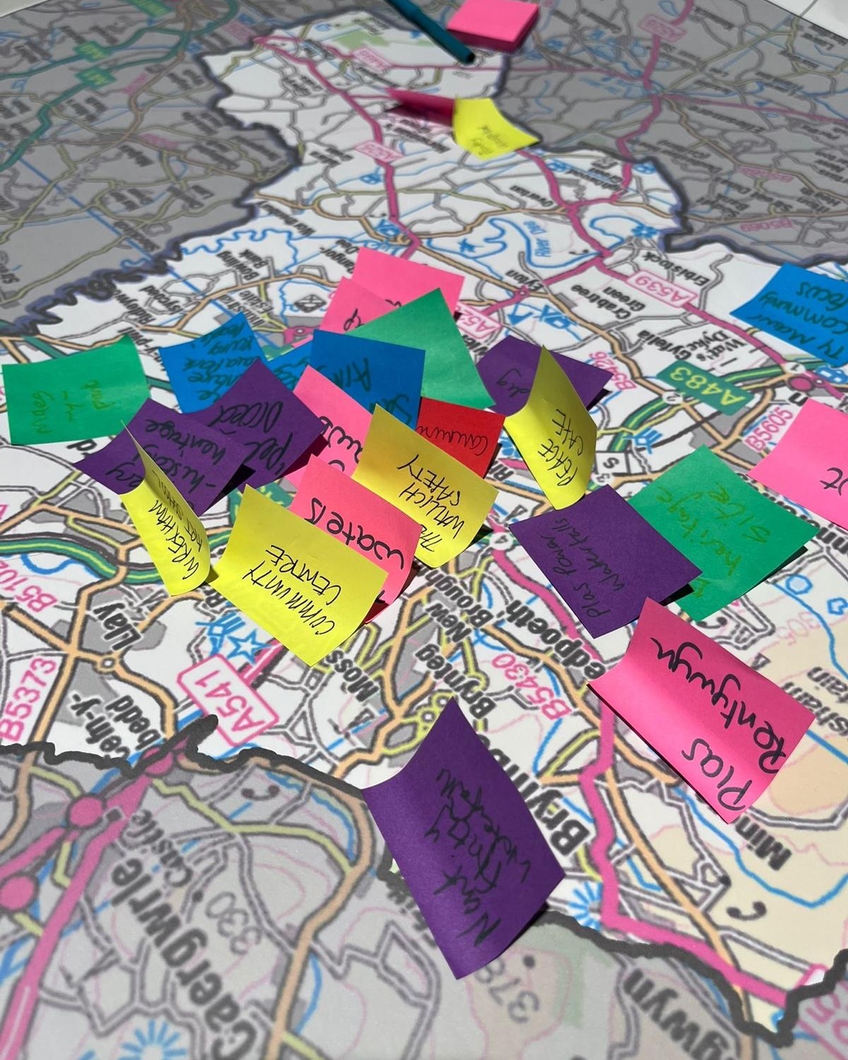 Sticky notes of locations on a map of Wales