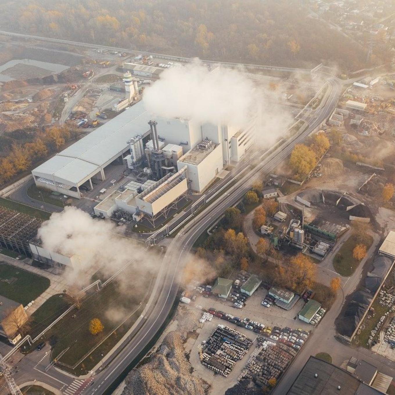 Ariel view of a factory producing smoke into the environment
