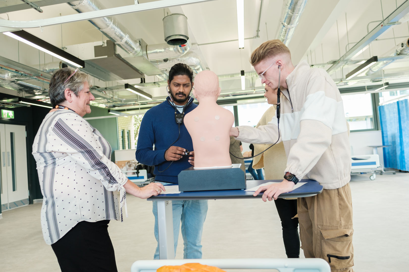 Students inspecting medical dummy