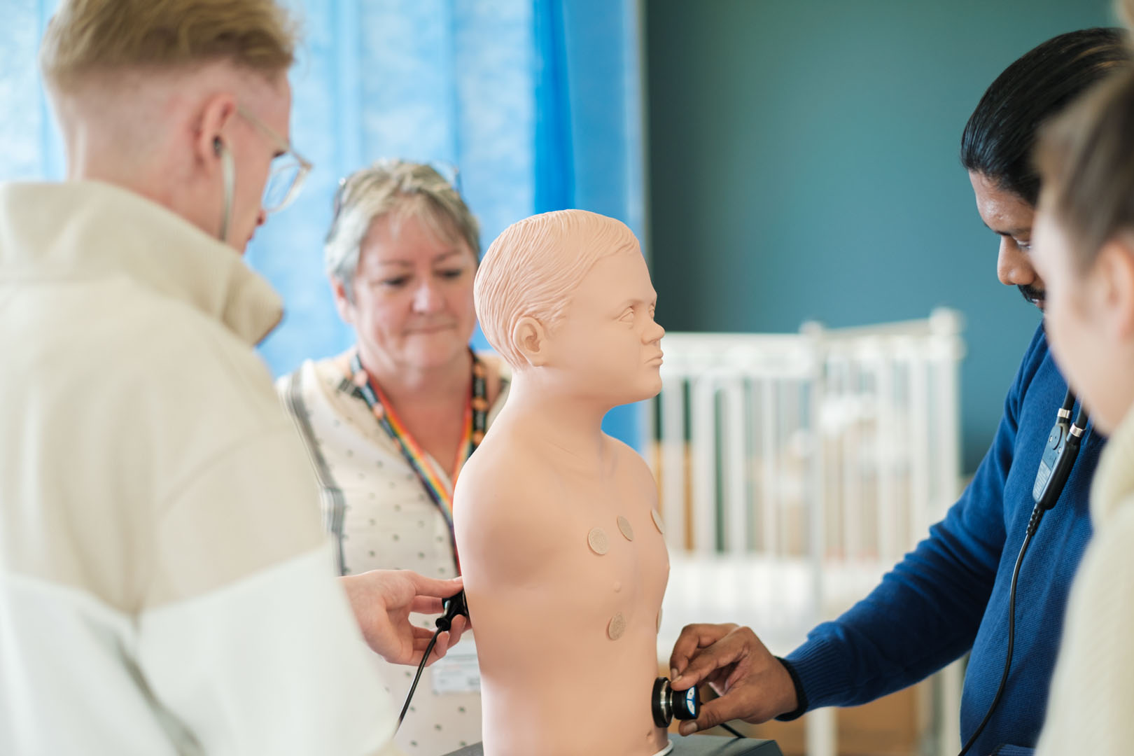 Students being assessed inspecting a medical dummy
