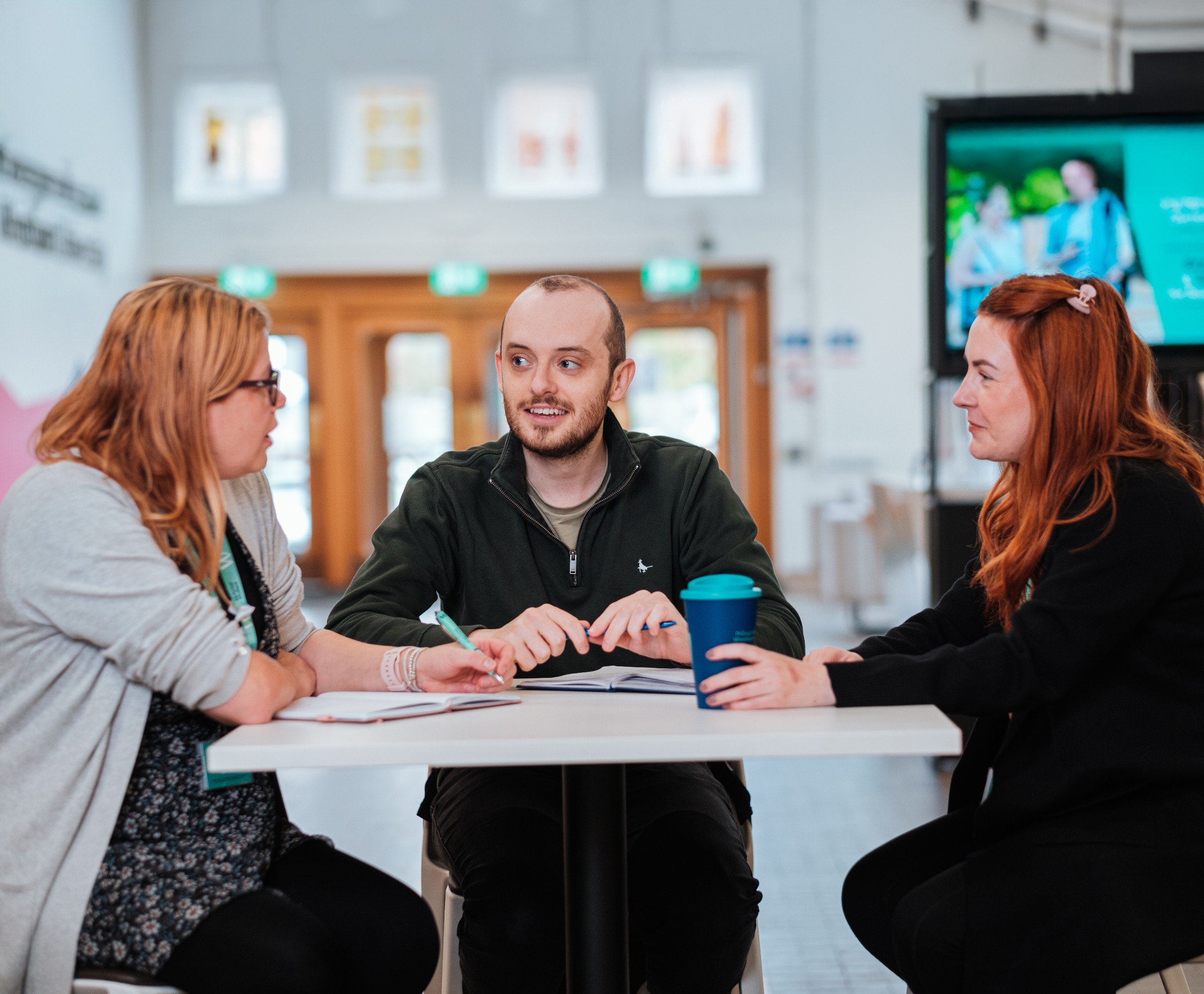 Postgraduate students talking on campus