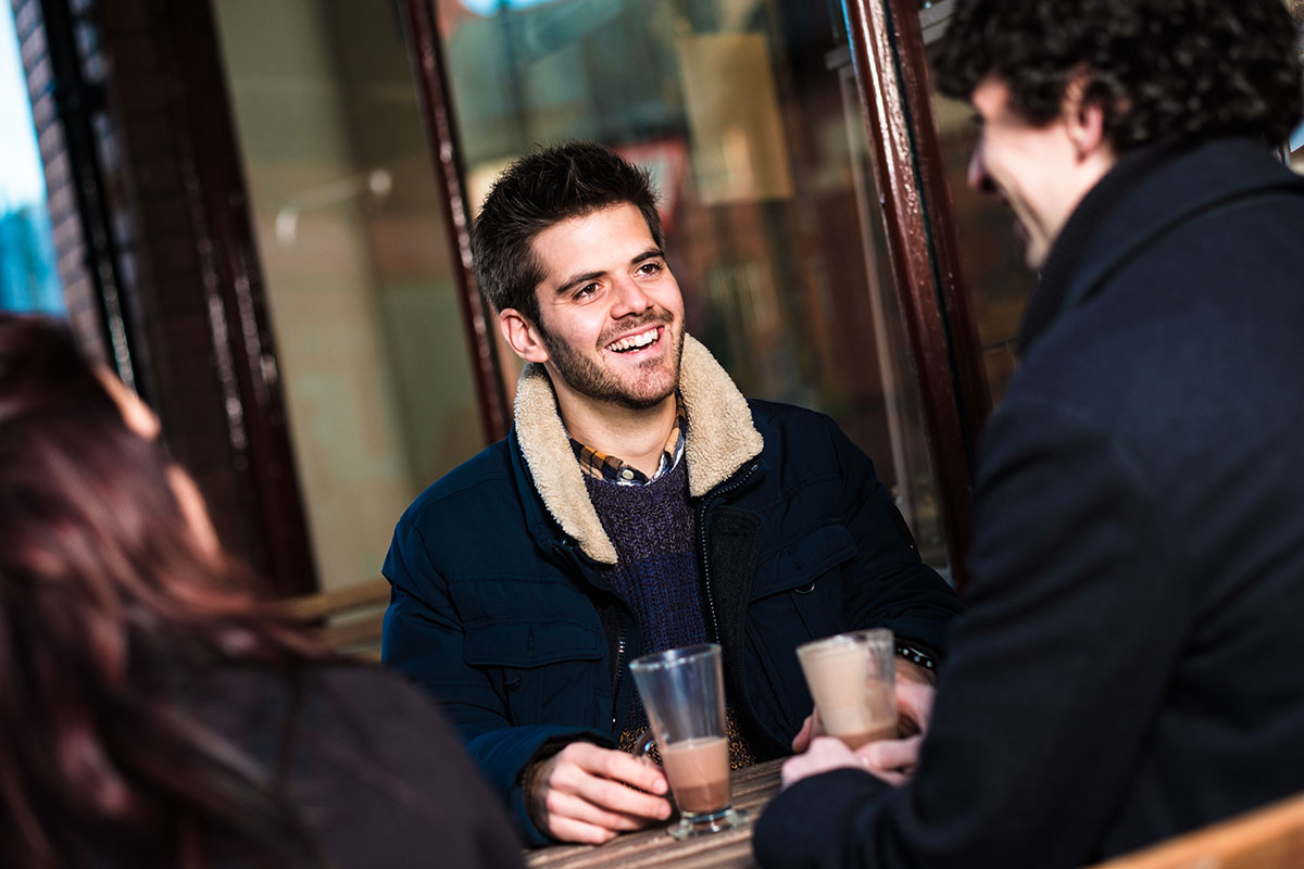 A group sitting outside a wrexham cafe