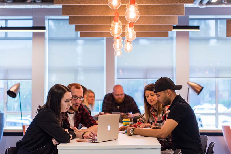 Students talking in a bright and creative environment