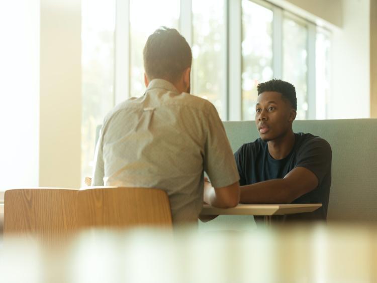 male students sitting face to face