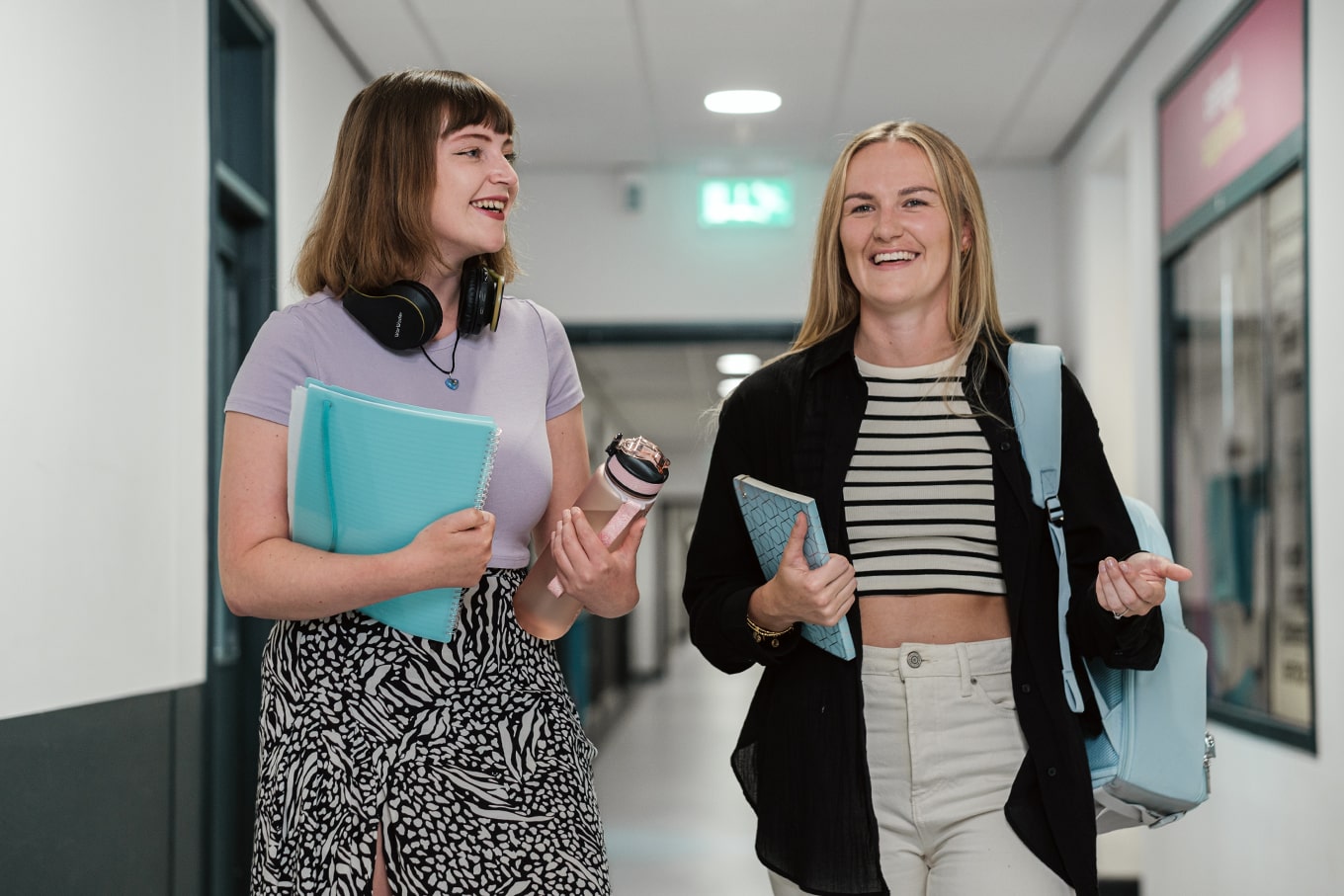 Two students in a corridor