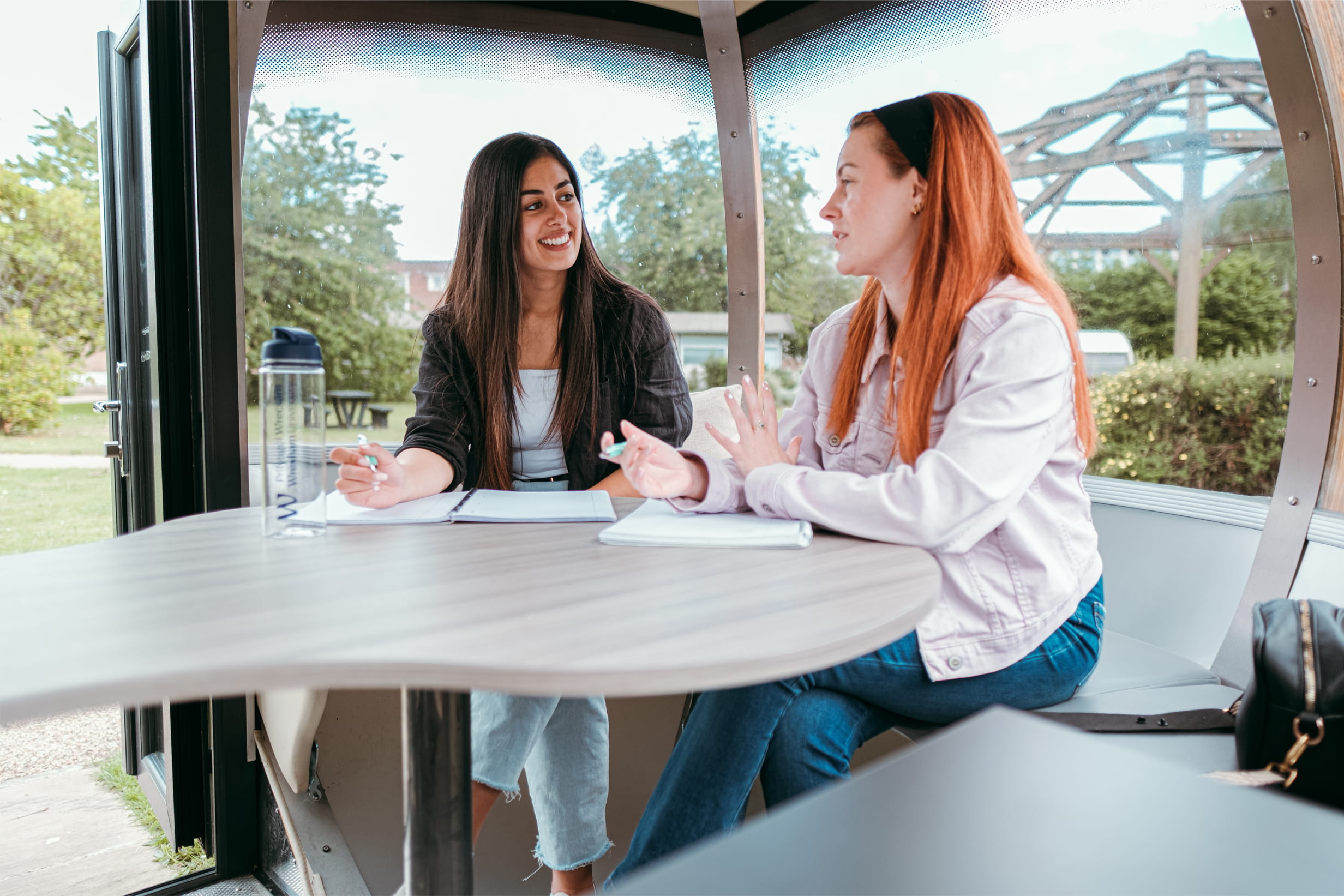 Students studying in a modern outside study pod