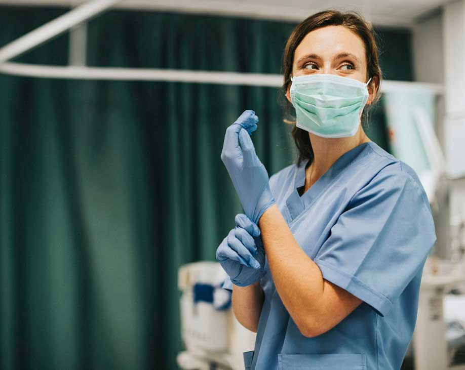 female nursing on a word with a mask and gloves on