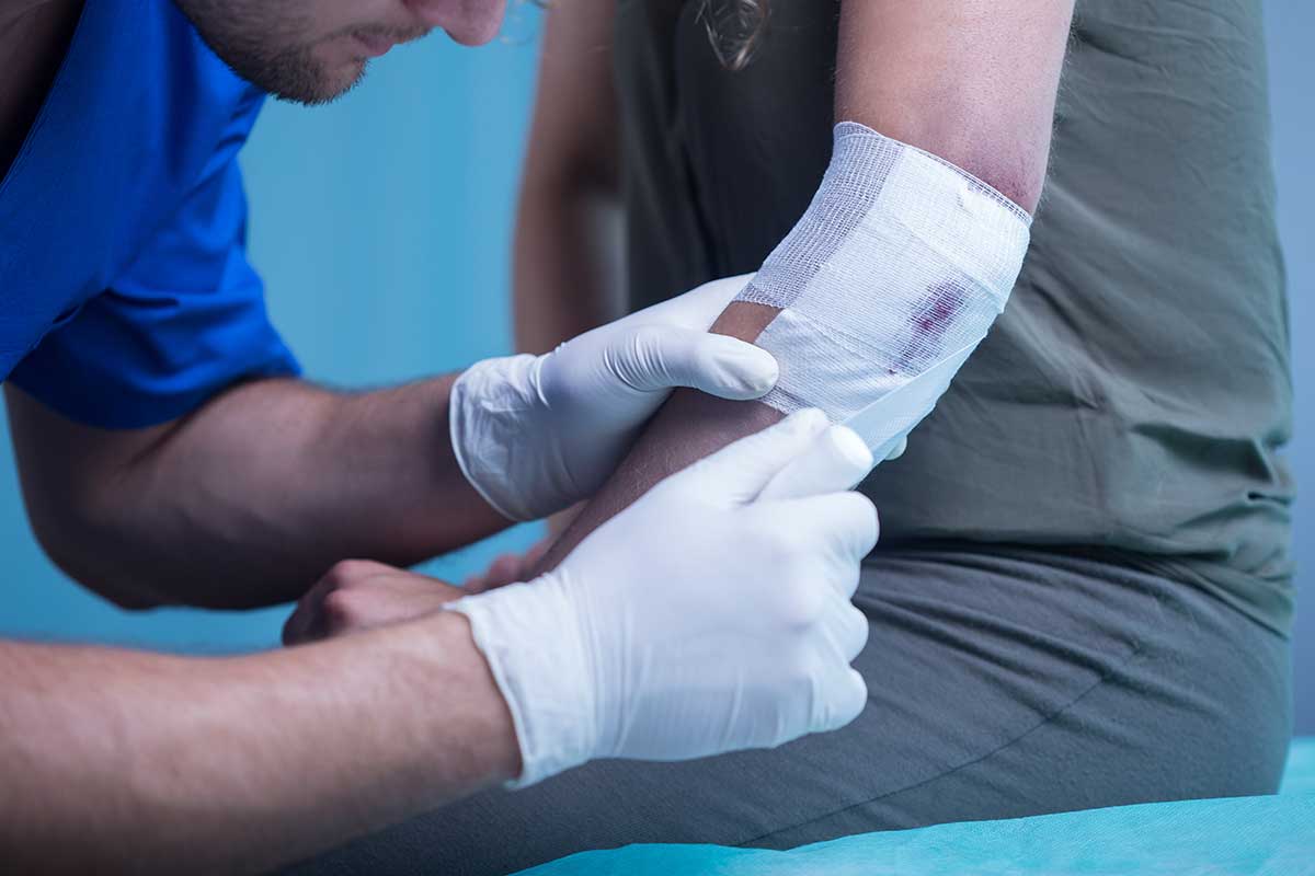 Nurse looking after a wound on an elbow