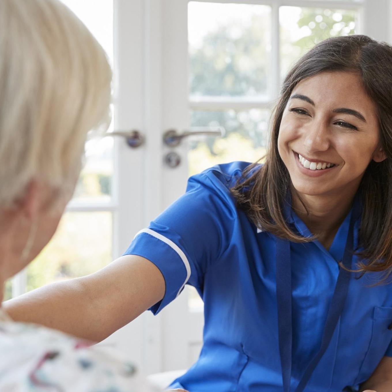 Nursing professional making a home visit to an elderly patient