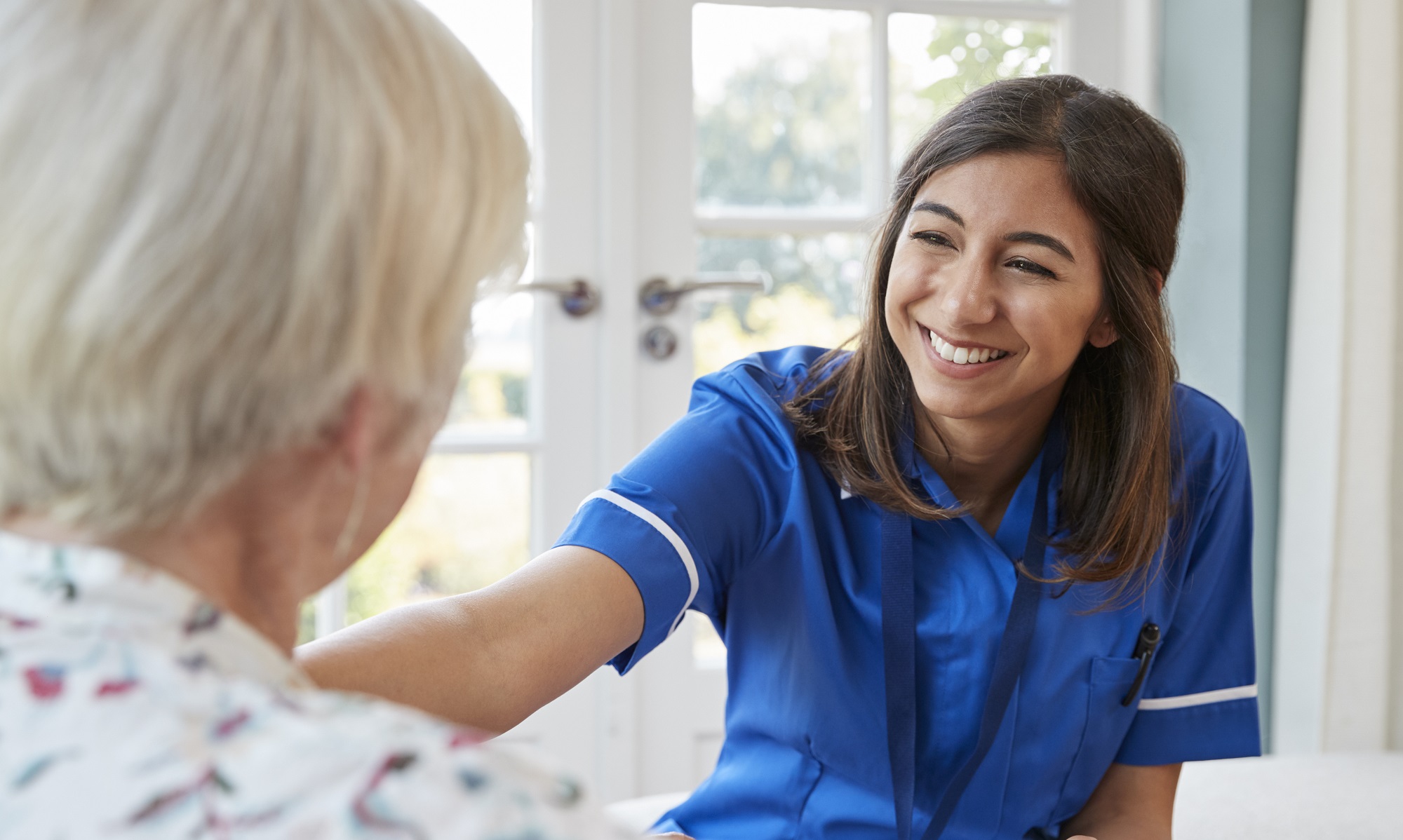 Nursing professional making a home visit to an elderly patient