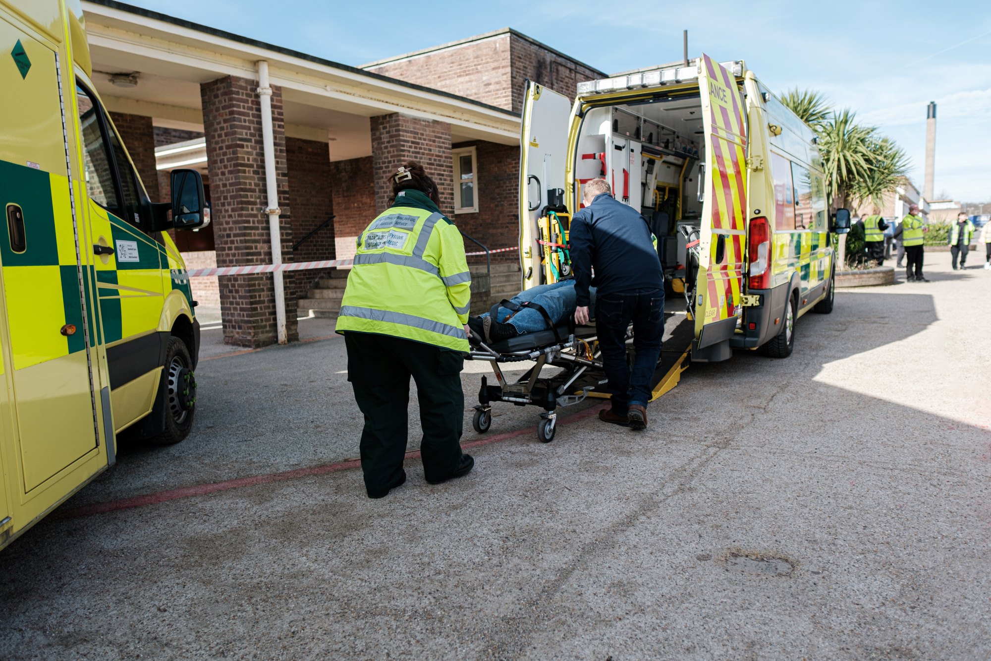 Students loading patient into ambulance