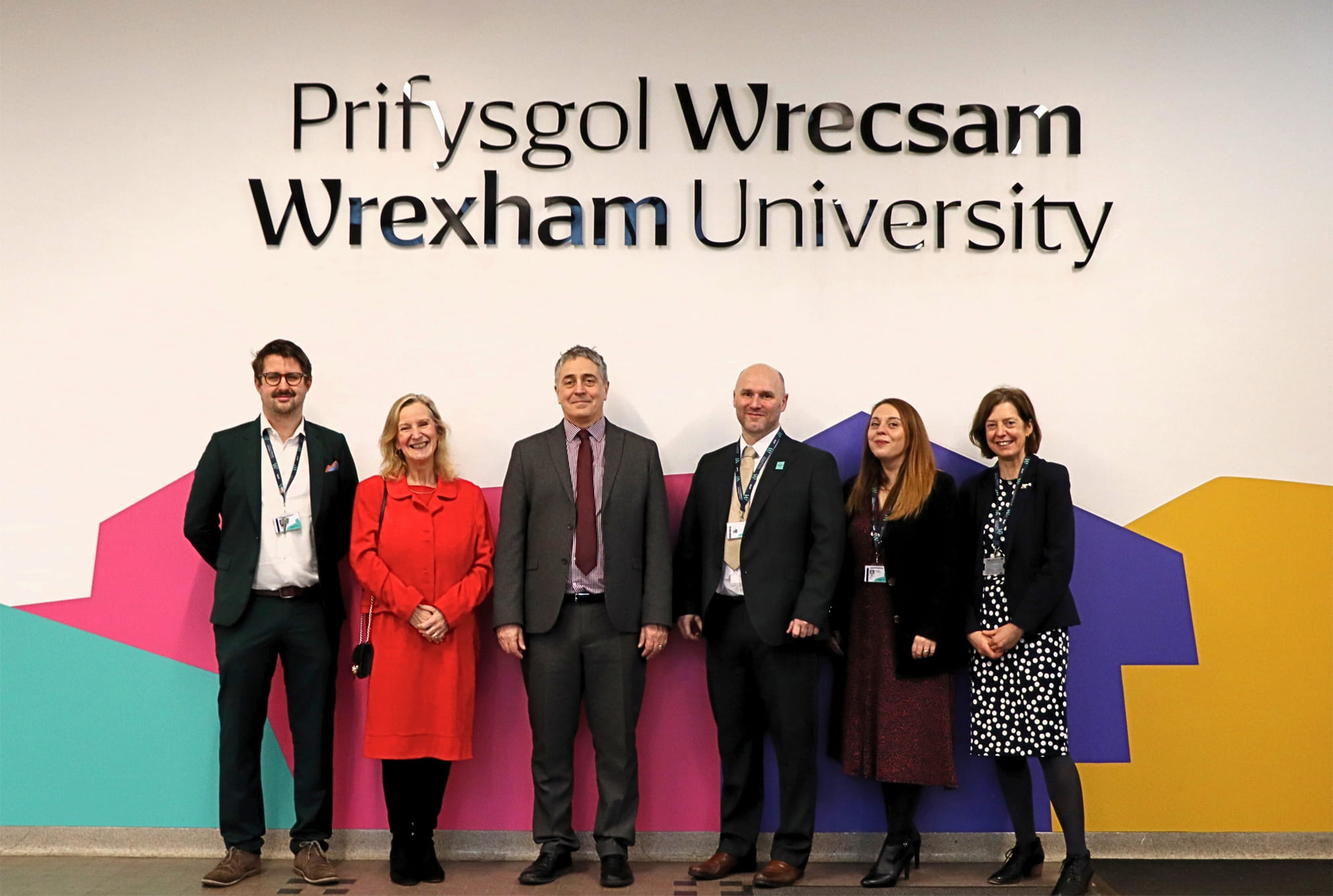 RDAPS Team standing in front of Wrexham university signage