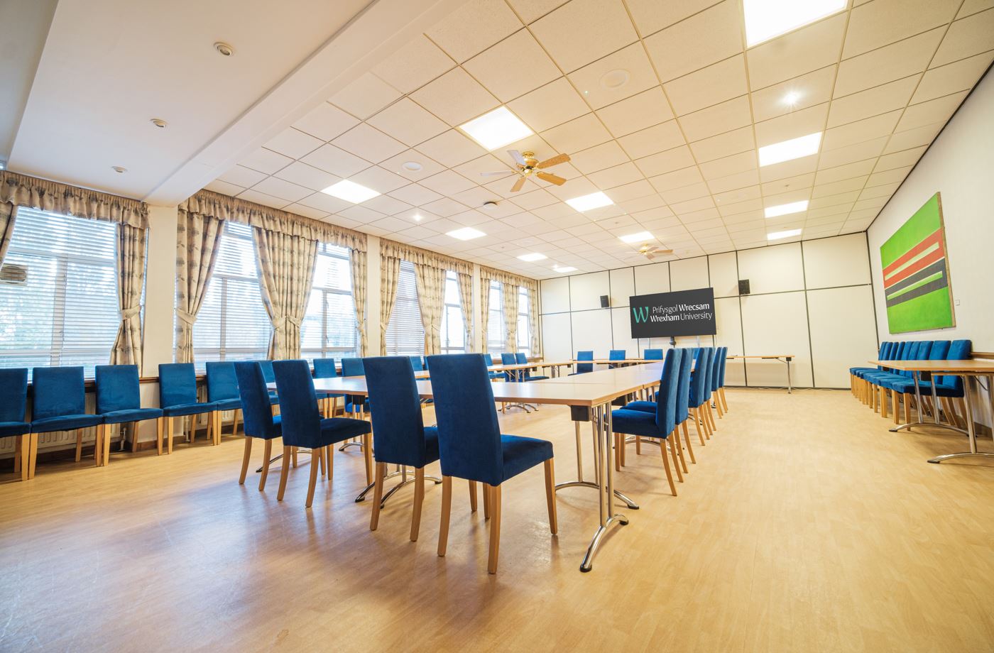 A room with tables and chairs in a boardroom layout
