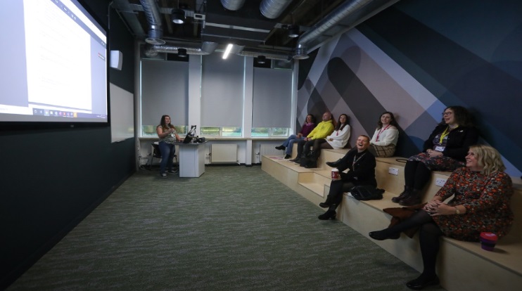 A group of students at a classroom lecture