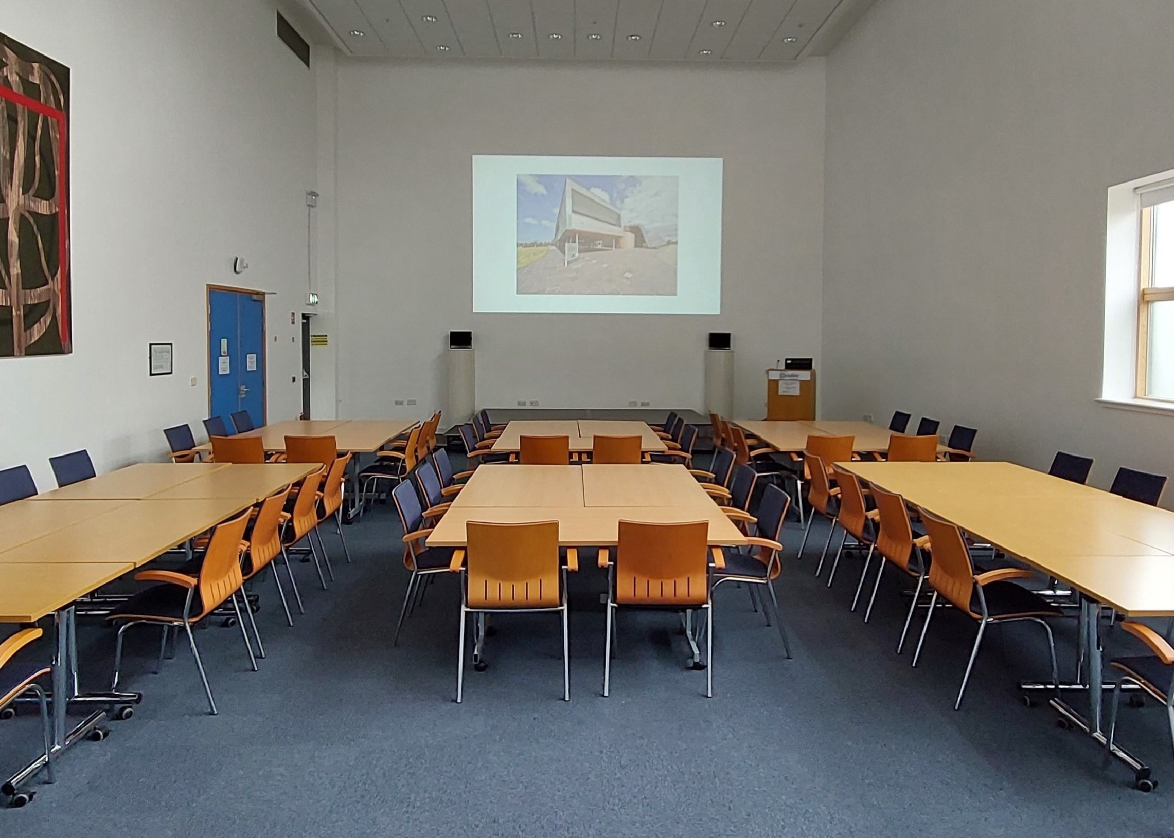 Tables and chairs in a large meeting room