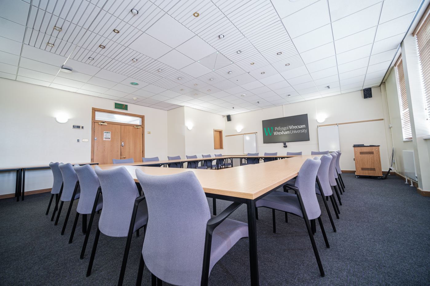 A room with tables and chairs in a boardroom layout