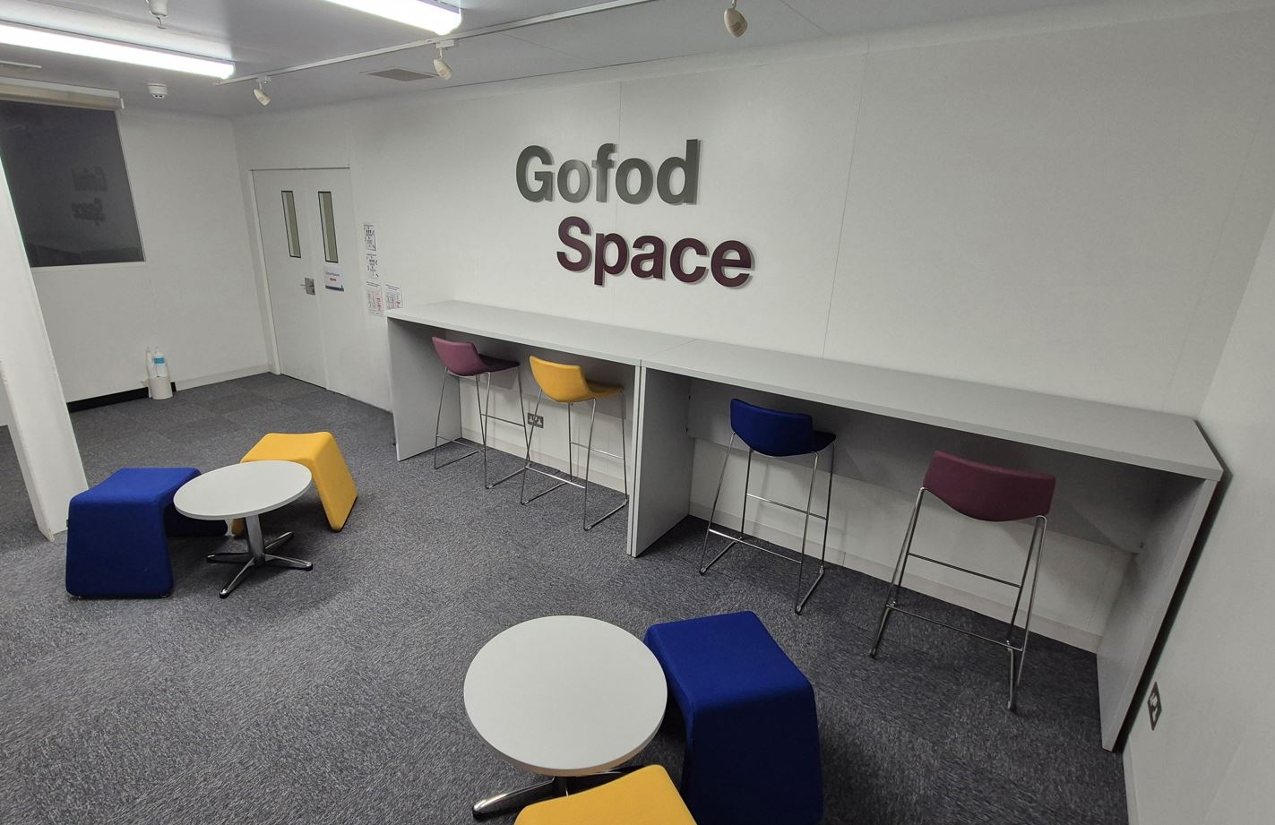 Tables and chairs laid out in a communal space