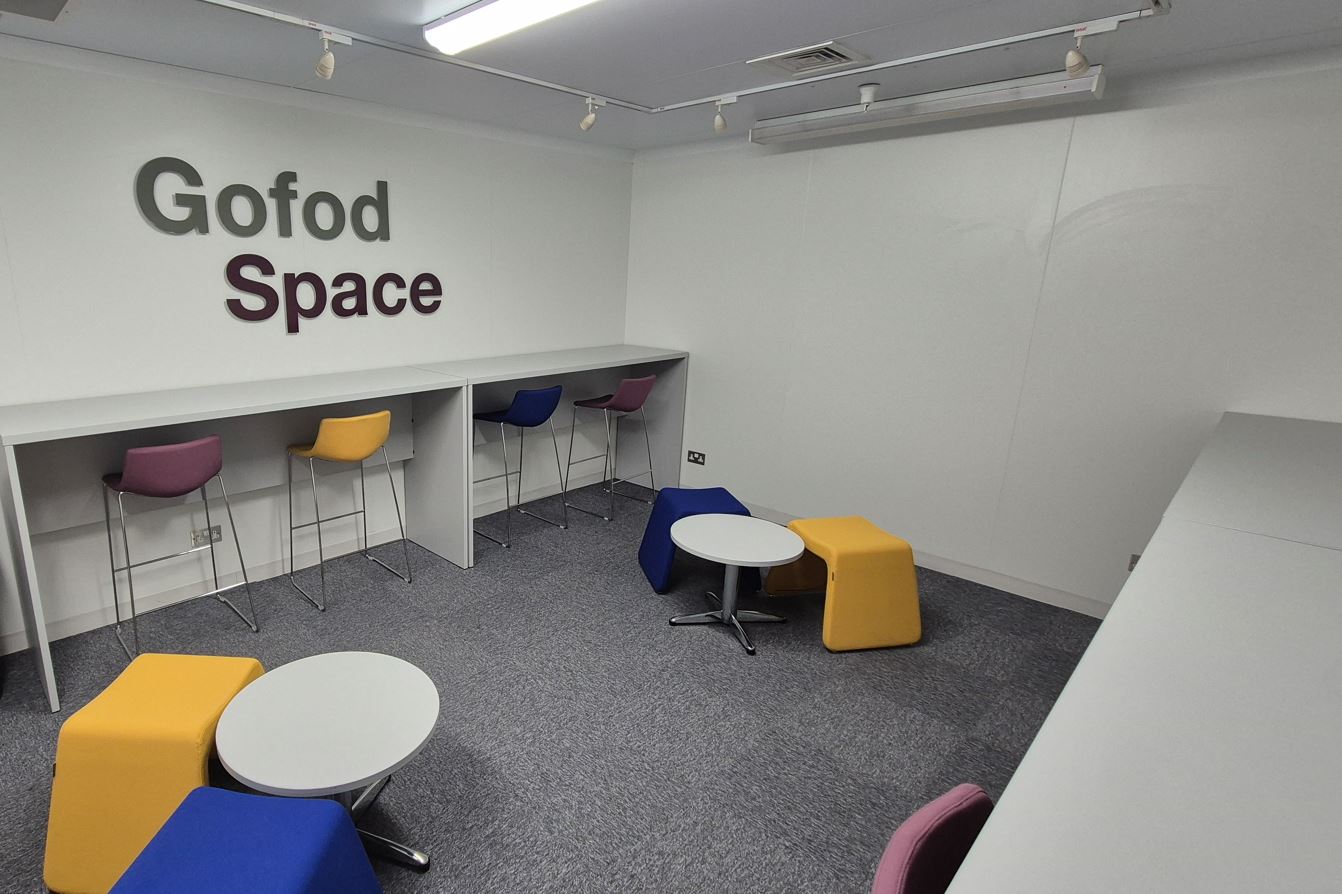 Tables and chairs laid out in a communal space