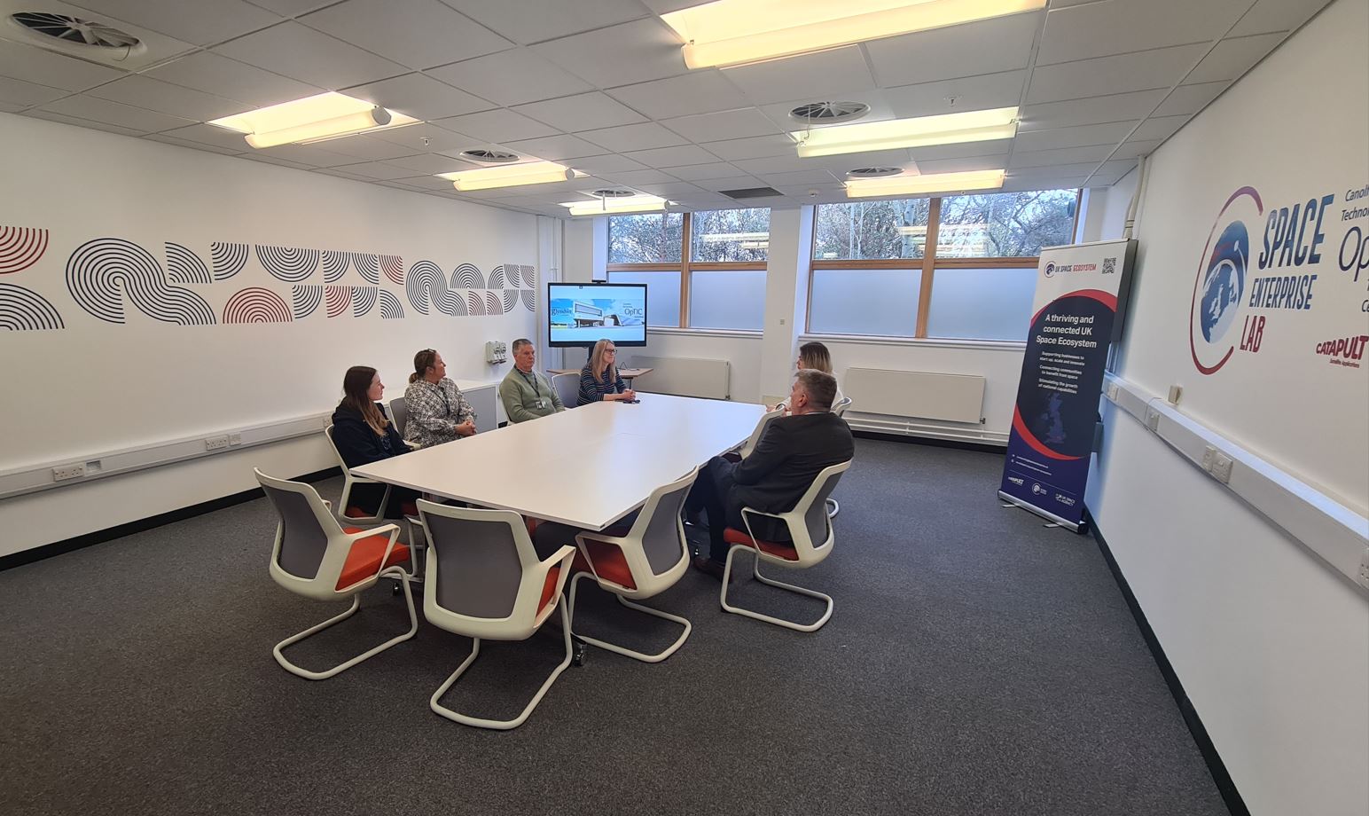 People sat around a table in a meeting room