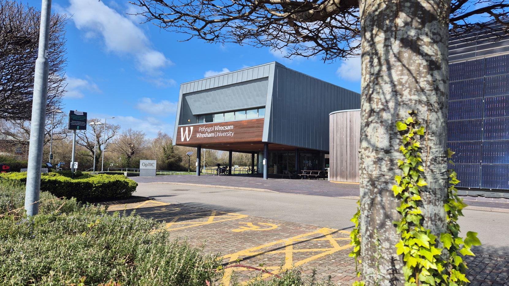 A building surrounded by trees on a sunny day