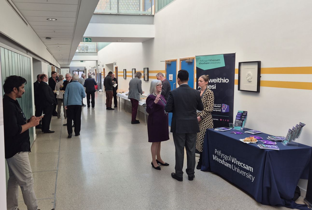 A group of people networking in an exhibition area