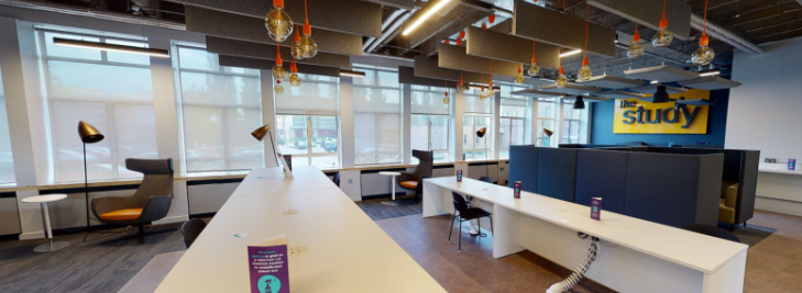 A communal area with tables and work benches