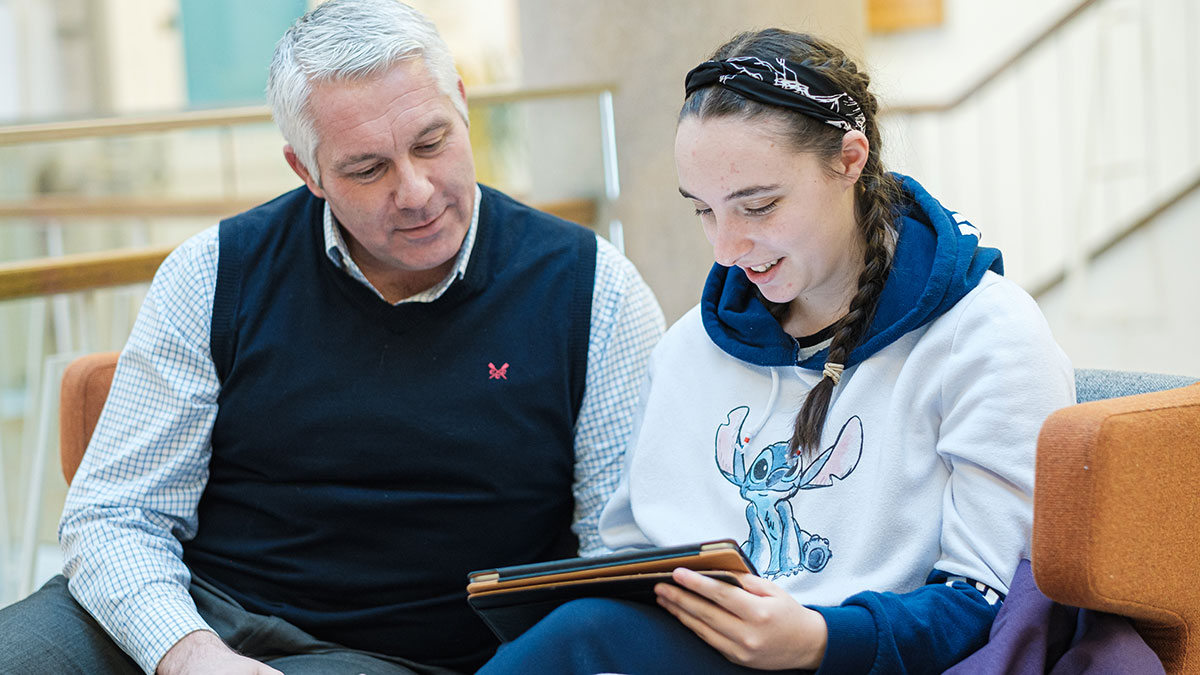 A Father and daughter looking at course info