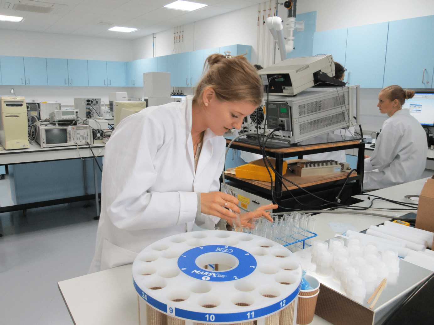 Student in a lab coat undertaking lab work