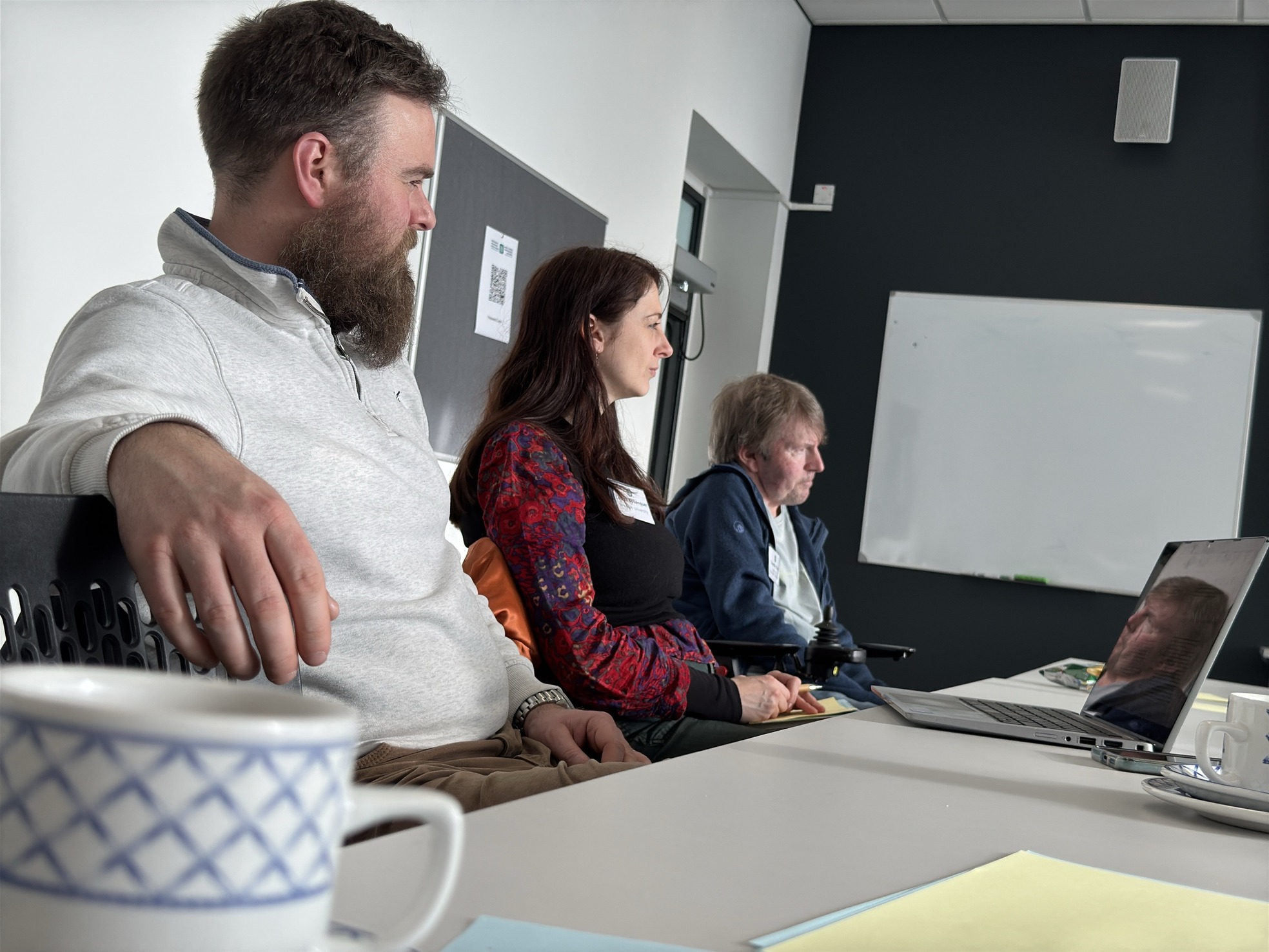 Three people at a table during a conference