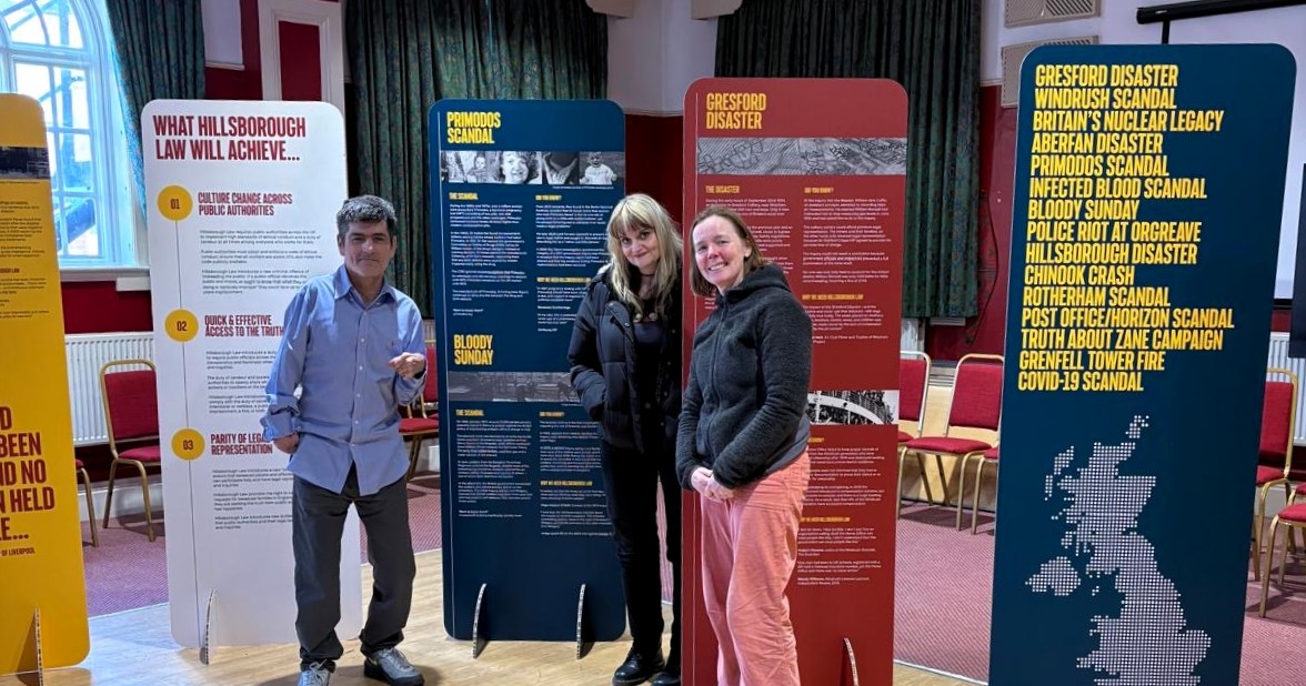 people standing next to the stands during the exhibition