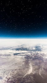 Dark skys, blue horizon and image of part of earth from space