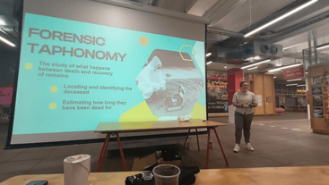 Researcher presenting in front of large screen