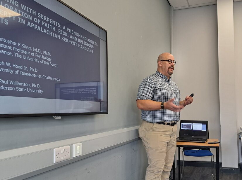 Chris presenting in front of a board
