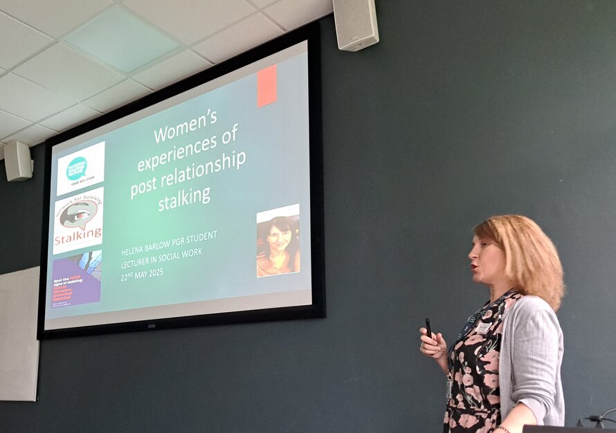 helena standing at the front of a room presenting